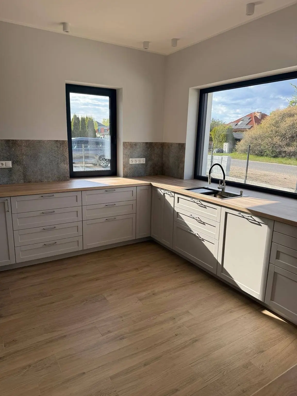 Gray kitchen cabinetry with brass handles