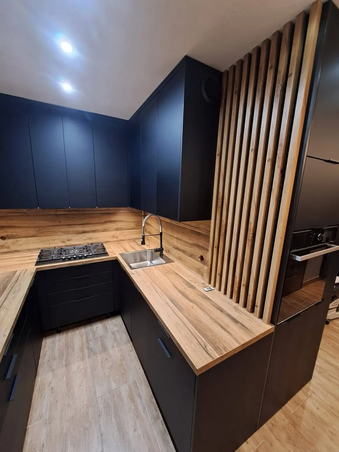Gray and oak kitchen with integrated appliances