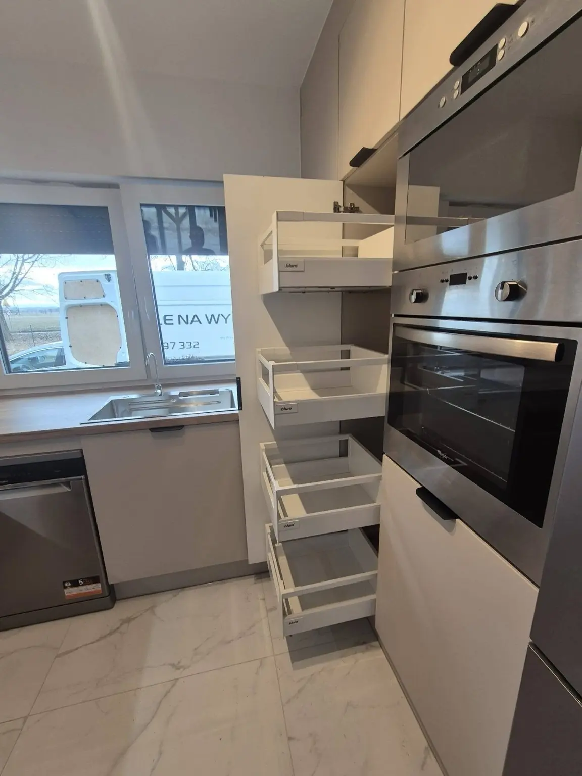 Tall kitchen cabinet with multiple pullout storage drawers