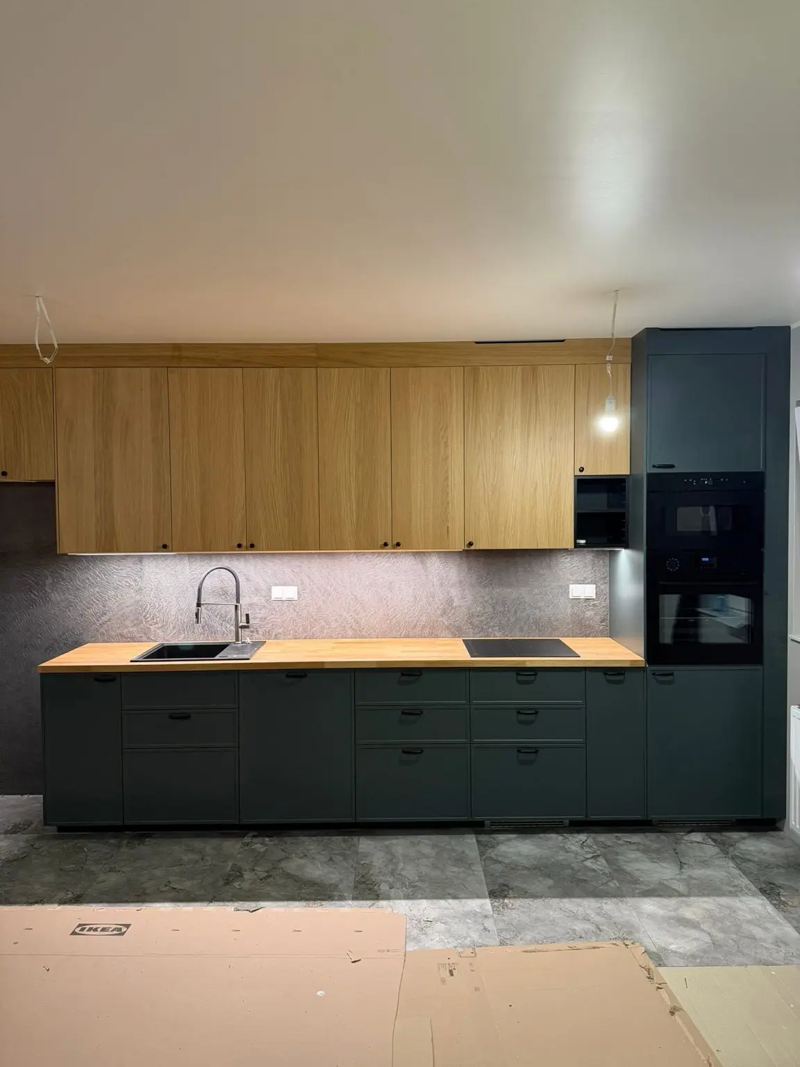 Minimal kitchen with oak countertop and full-height cabinetry