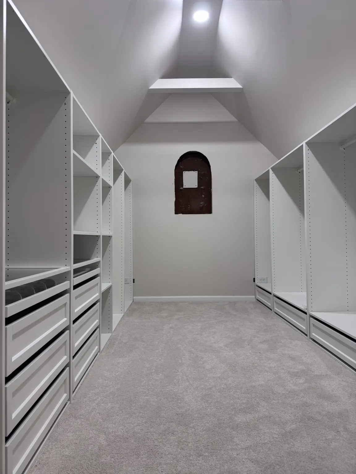 White attic dressing room with storage on both sides