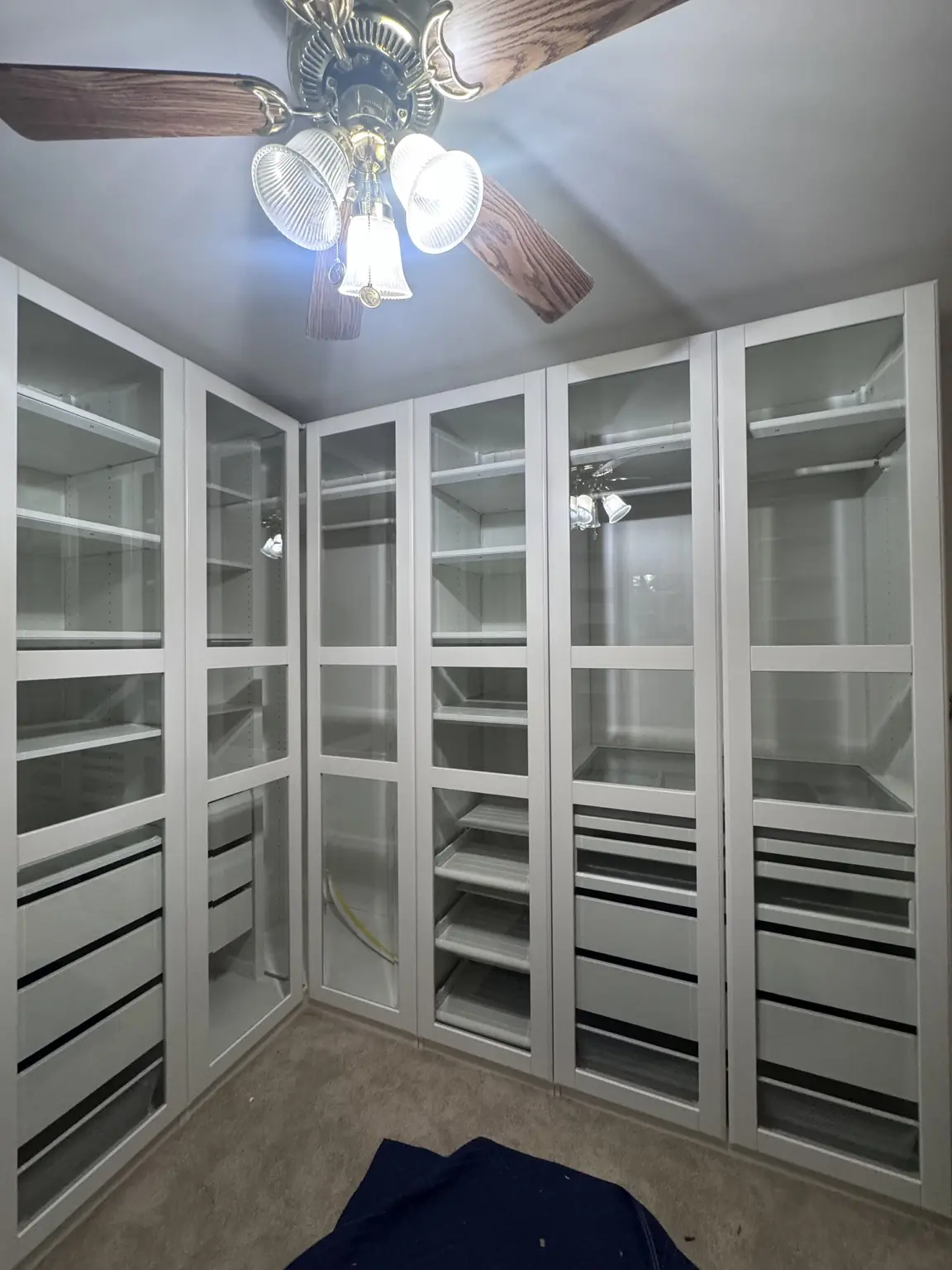 White wardrobe with tall glass-front doors