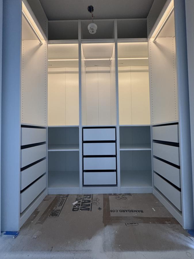 White built-in closet with lighting